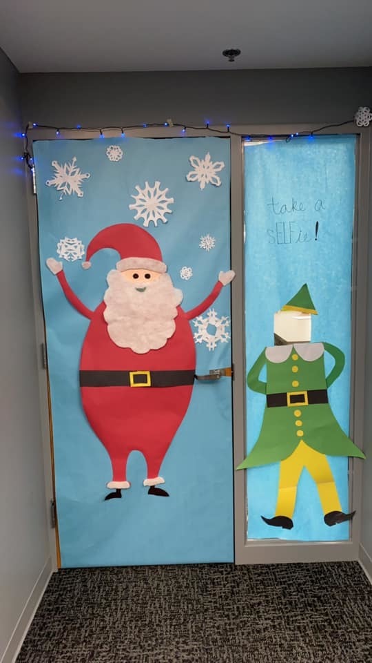 Door with Santa and an elf next to it that says "Take a sELFie!"
