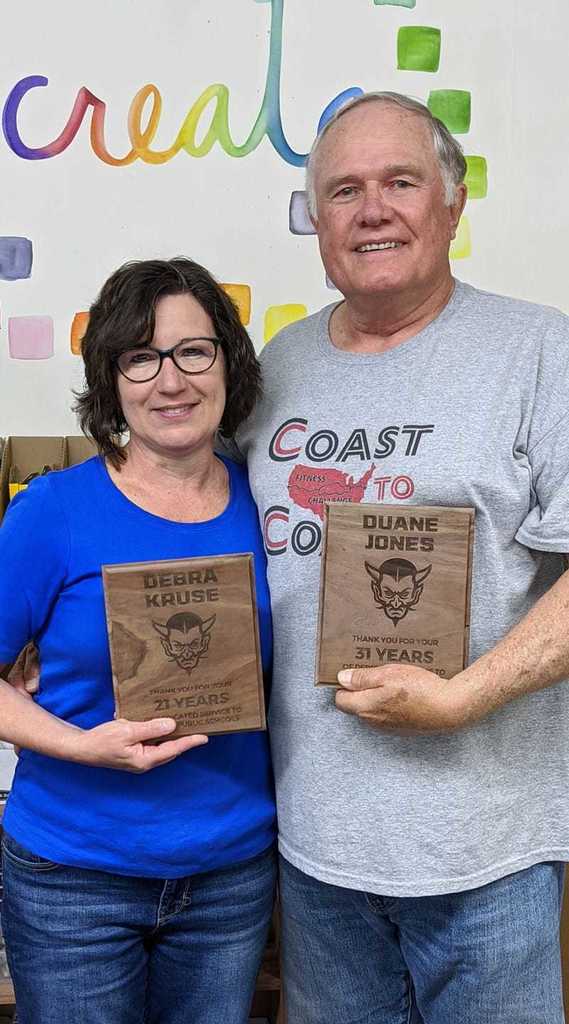 Debra Kruse and Duane Jones holding awards